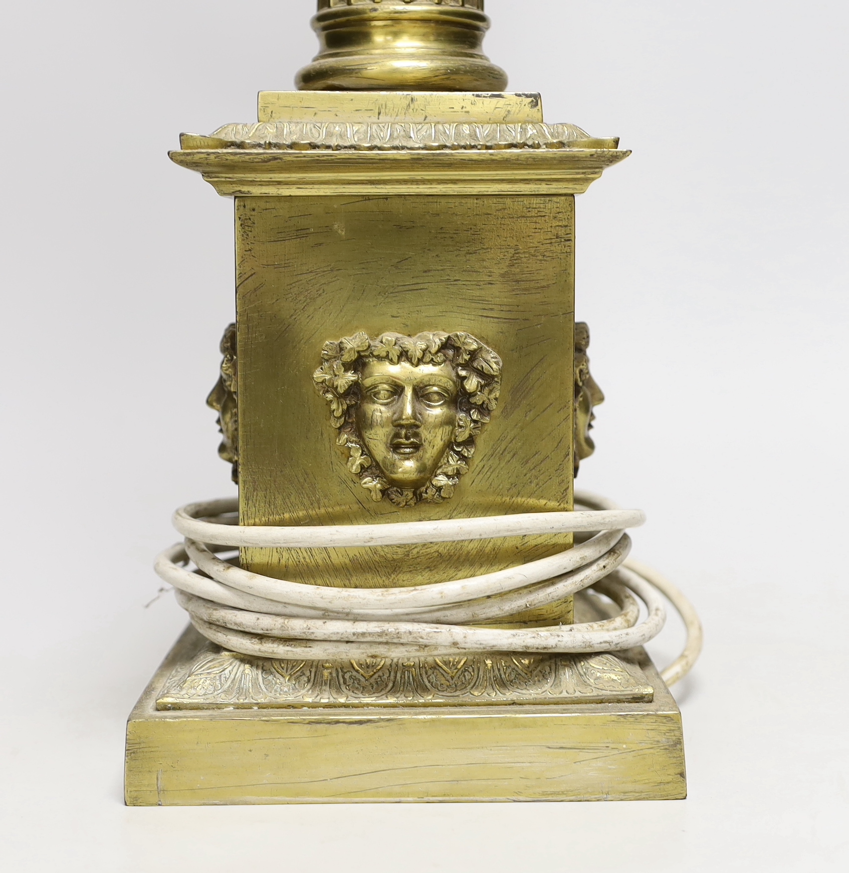 A large brass desk lamp in the form of a tapering column, on plinth base, 56cm to top of column